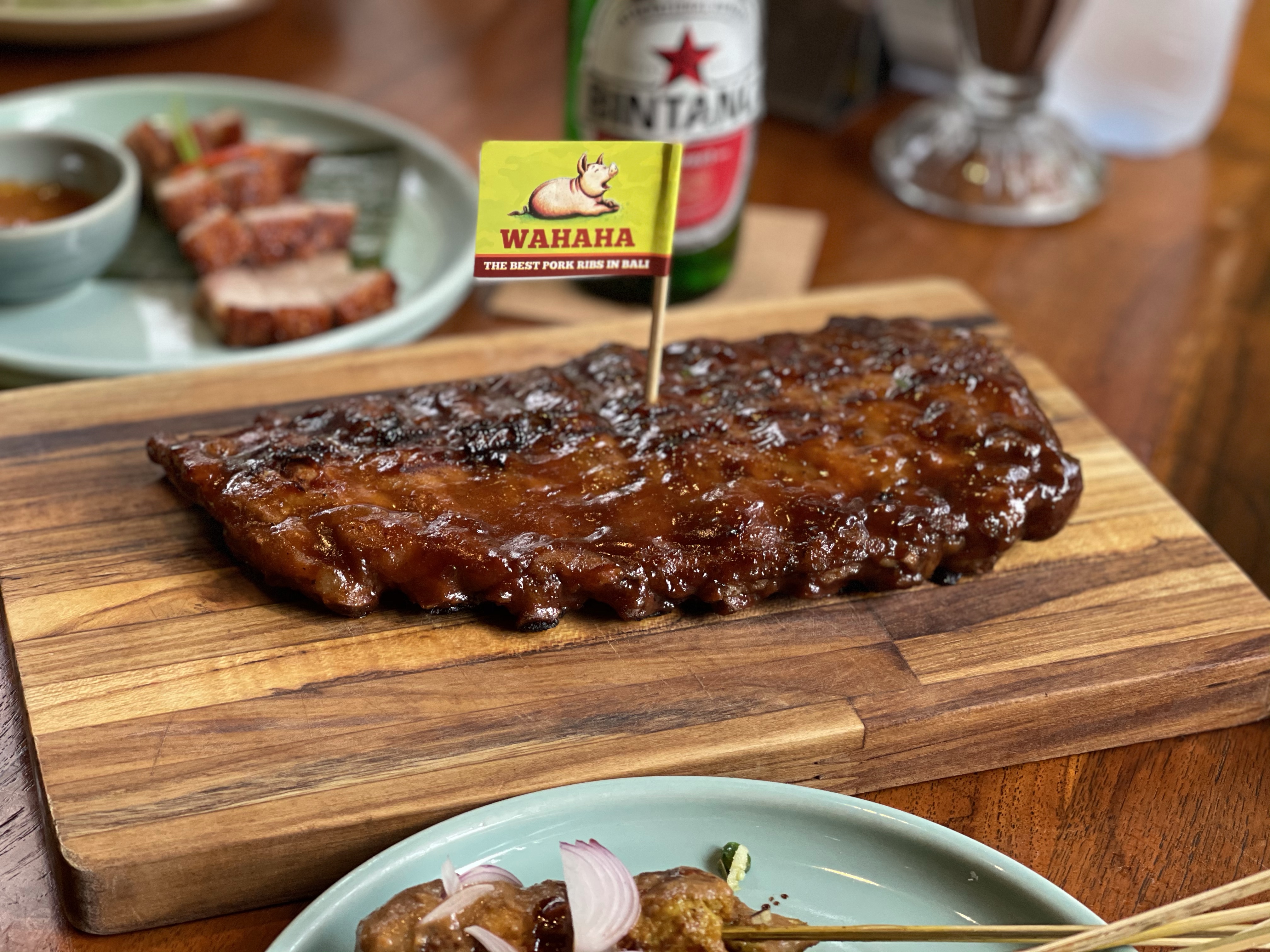 Savor the unique blend of Balinese herbs and spices with the legendary WAHAHA Pork Ribs fire-grilled to perfection and drizzled in a mouthwatering BBQ sauce that promises unforgettable flavor.