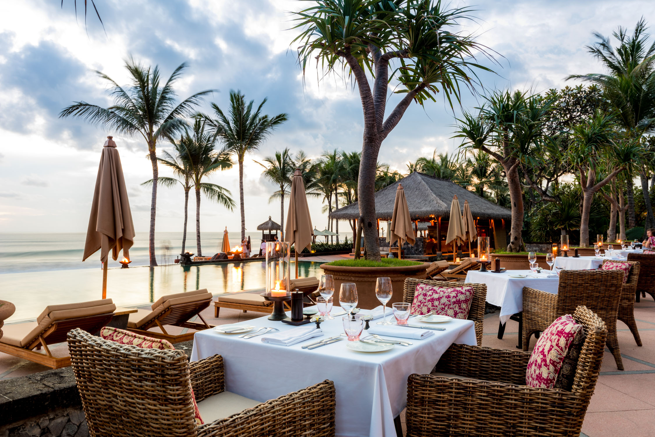 Experience exquisite dining at The Legian Seminyak where stunning ocean views and a fusion of European and Southeast Asian flavors create unforgettable moments amidst Bali's serene landscape.