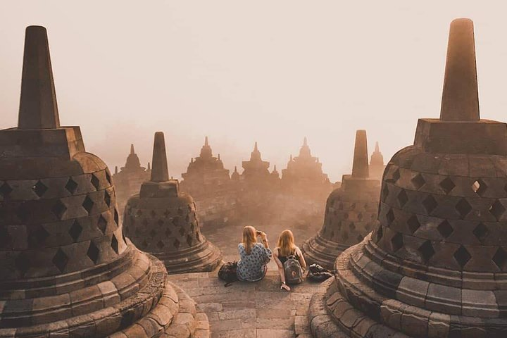 As the sun rises over Borobudur ancient stupas create a stunning backdrop for moments of reflection capturing the essence of Javanese culture and the beauty of the surrounding landscape.