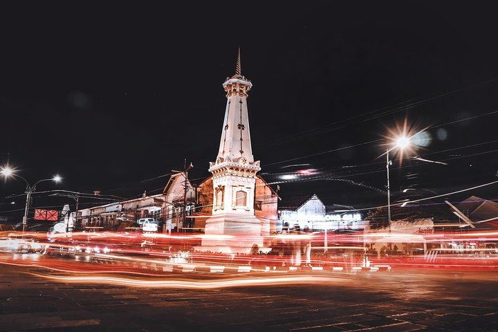 Experience the lively energy of Yogyakarta's iconic landmarks at night with stunning illumination and the rhythmic flow of local life perfect for exploring the city's rich culture.