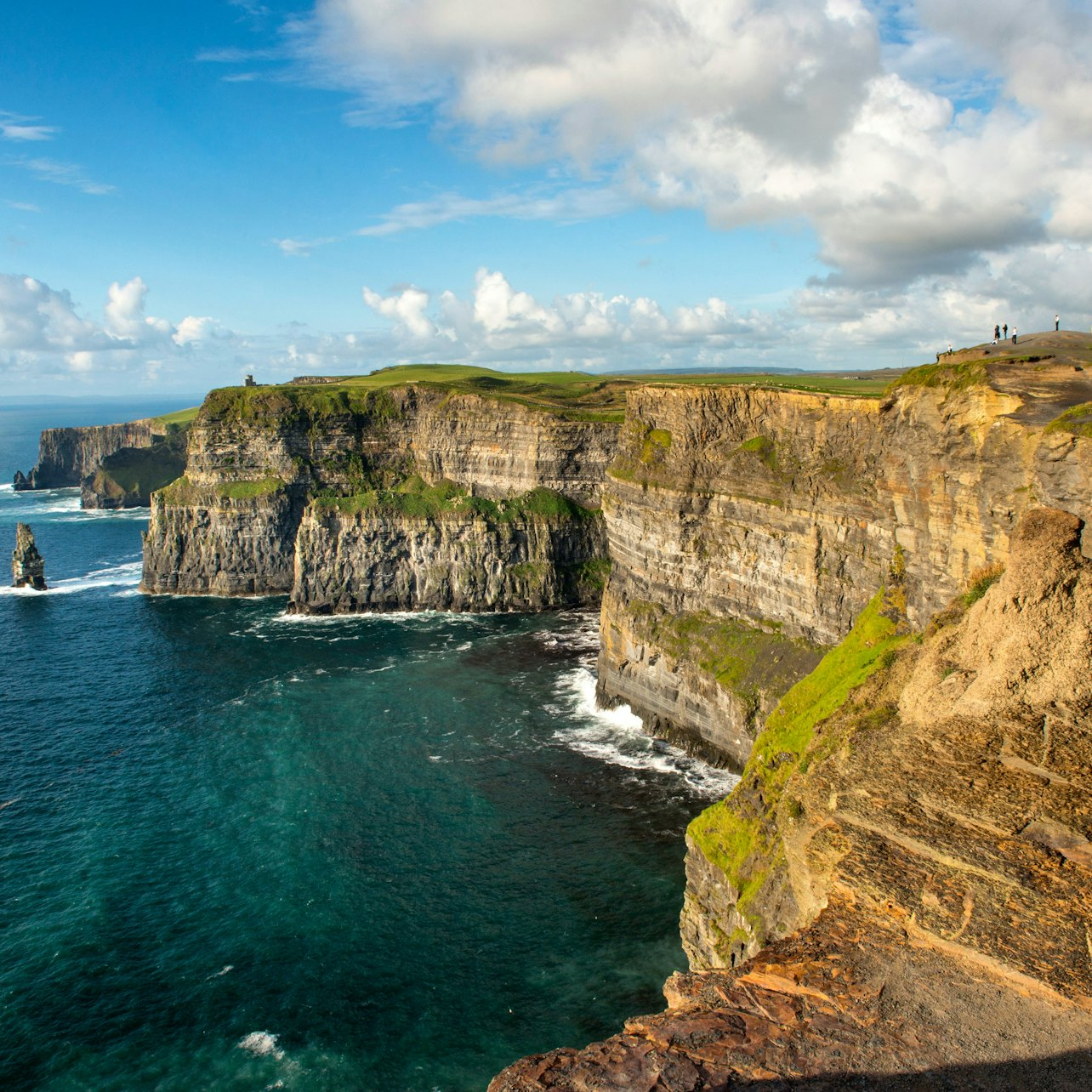 Experience the rugged beauty of the Cliffs of Moher where dramatic cliffs meet the roaring Atlantic offering perfect opportunities for memorable photos and a deep connection with Ireland's natural wonders.
