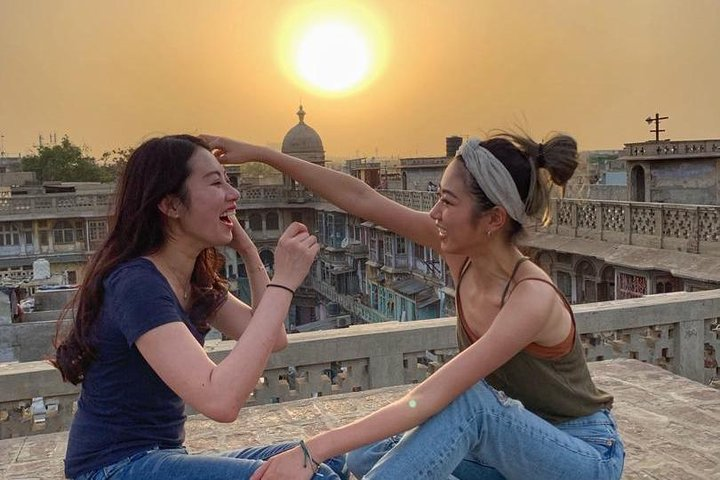 Guests Having Fun and enjoying sun set at the secret Roof Top In Old Delhi