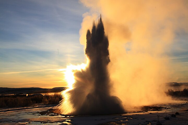 Strokkur on Geyser area, front of sunset. 
