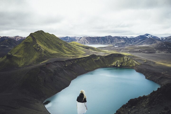 Experience the stunning contrast of rugged mountains and crystal-clear lakes inviting exploration and reflection in Landmannalaugar's unique landscape perfect for adventurers and nature lovers alike.