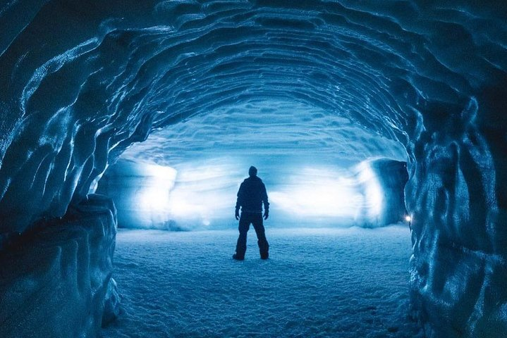 Explore stunning ice cave tunnels where brilliant blue light illuminates ancient glaciers offering a unique glimpse into Iceland's mesmerizing underground world. A must-see for adventure seekers!