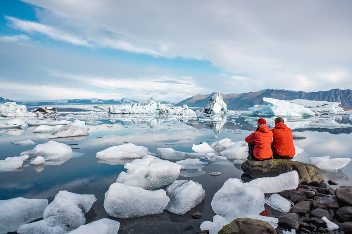 Witness the stunning beauty of Iceland as you sit by glacier lagoons surrounded by delicate ice formations and majestic landscapes a perfect moment for explorers and nature lovers alike.