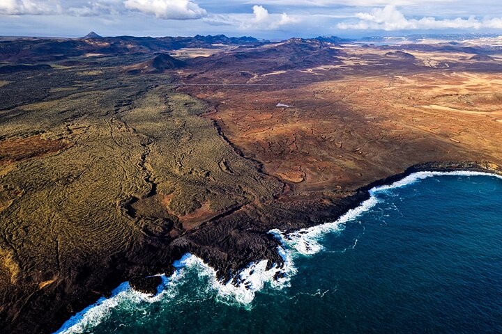 Experience stunning views of the Reykjanes peninsula with dramatic lava fields meeting the coastline. Discover the rugged beauty of Iceland’s volcanoes from a unique aerial perspective.