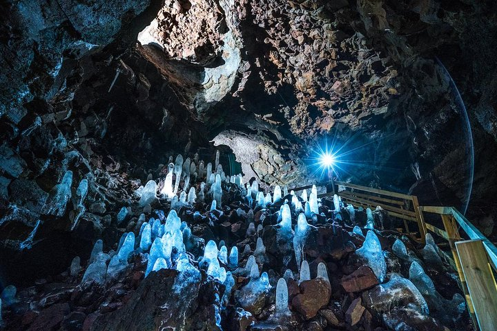 Discover the stunning formations within Viðgelmir Lava Cave where natural sculptures glisten under subtle lighting inviting exploration in the unique landscapes of Iceland's rugged beauty.