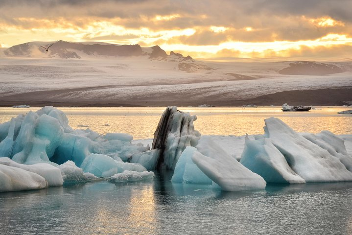 Experience the breathtaking beauty of Jokulsarlon glacier lagoon with stunning icebergs glistening in the light and majestic mountains framing the serene waters—perfect for memorable adventures and photography.