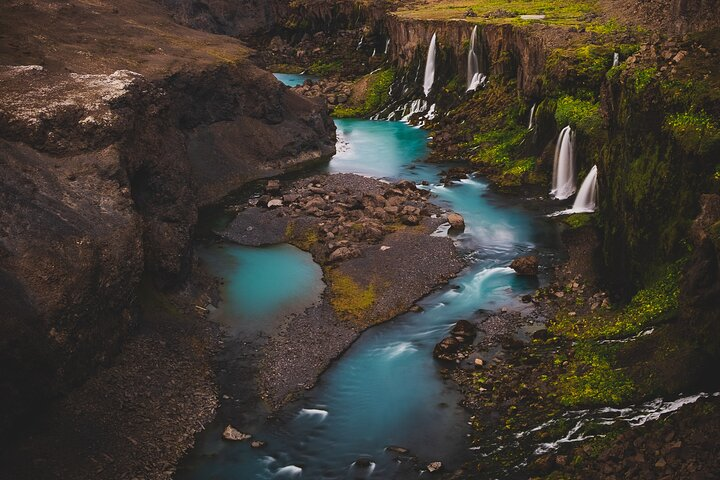 Experience the serene beauty of Iceland's hidden waterfalls and lush landscapes where crystal-clear waters flow amidst rugged terrain inviting exploration and unforgettable memories in the highlands.