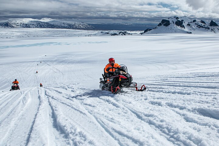 Experience the thrill of zooming across Iceland's vast glaciers surrounded by stunning snowy landscapes on an unforgettable snowmobile adventure that promises memories for a lifetime.