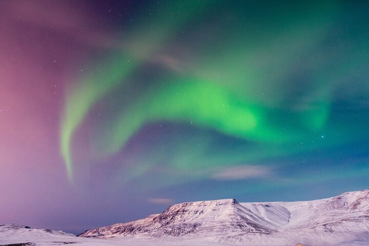 Experience the magic of Iceland with a hike to a live volcano and a spectacular view of the northern lights blending adventure with breathtaking natural beauty.