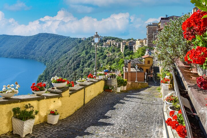 Wander through charming streets lined with colorful blooms where stunning views of Nemi Lake await. Indulge in local wines and explore the rich history of Frascati and beyond.