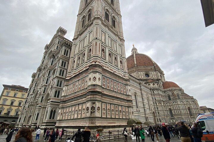 Experience the remarkable architecture of Florence's Duomo complex where history meets breathtaking views from Brunelleschi's Dome after a climb of 463 steps amid fellow explorers.