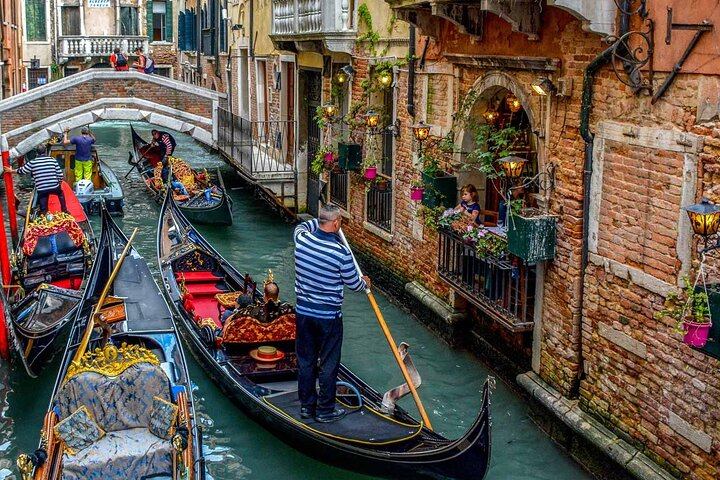 Glide through serene canals on a gondola surrounded by historic architecture and charming bridges. Experience the essence of Venice with every stroke of the oar.