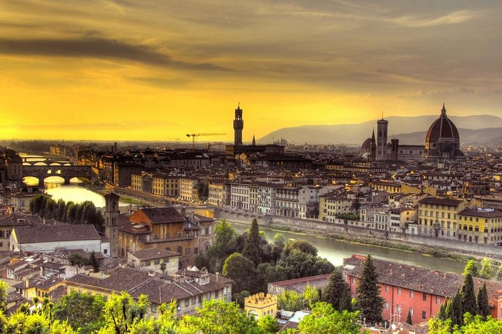 Experience Florence's iconic skyline as the sun sets revealing stunning architecture and serene waters making every moment on this guided cart tour truly unforgettable.