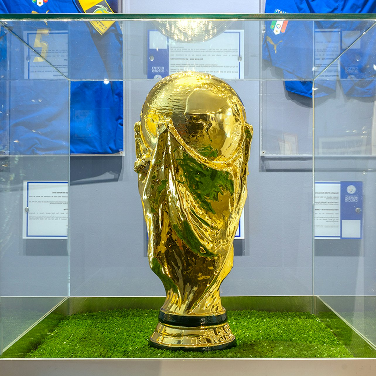 Explore the legacy of the Italian national football teams featuring iconic memorabilia like the World Cup trophy surrounded by stories of triumph and historic moments.