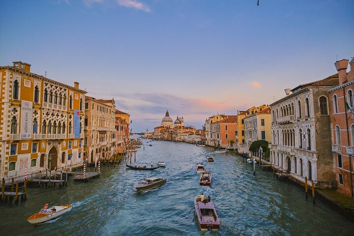 Discover the unique waterways of Venice where historic buildings line the canals and charming boats glide by creating an unforgettable experience during your day trip from Florence.