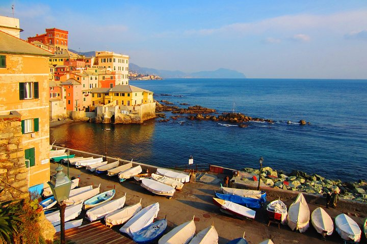 Explore the stunning coastline and charming architecture of Genoa where boats line the harbor inviting you to soak in the beauty of Italy's picturesque seaside towns.