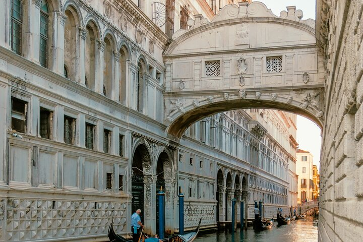 Experience the charm of Venice as you glide through serene canals beneath the Bridge of Sighs soaking in the rich history and romance of this iconic destination.