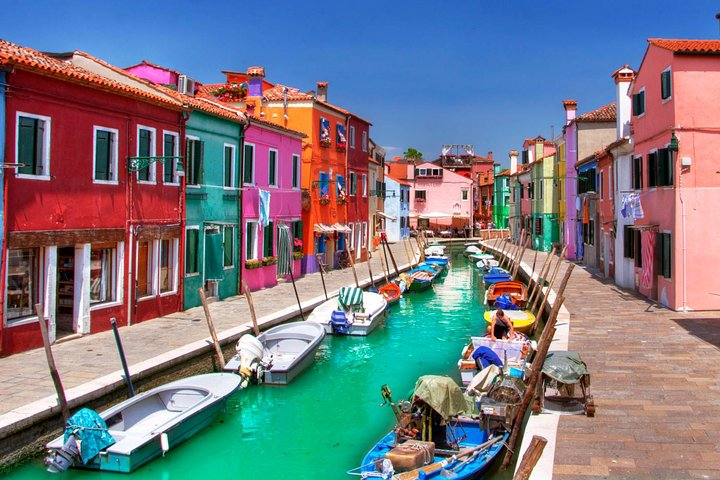 Experience the charm of Murano and Burano with their colorful houses lining tranquil canals perfect for leisurely exploration and rich cultural discoveries during your Venetian Lagoon cruise.