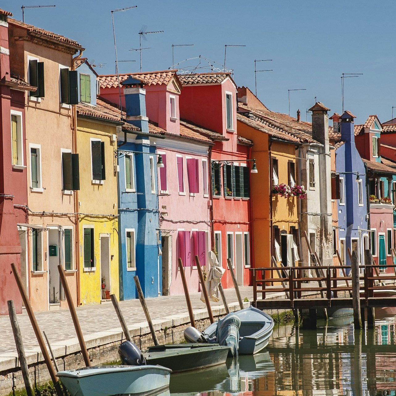 Explore the colorful streets of Burano where charming houses line the canals creating a picturesque backdrop for leisurely walks and delightful discoveries around every corner.