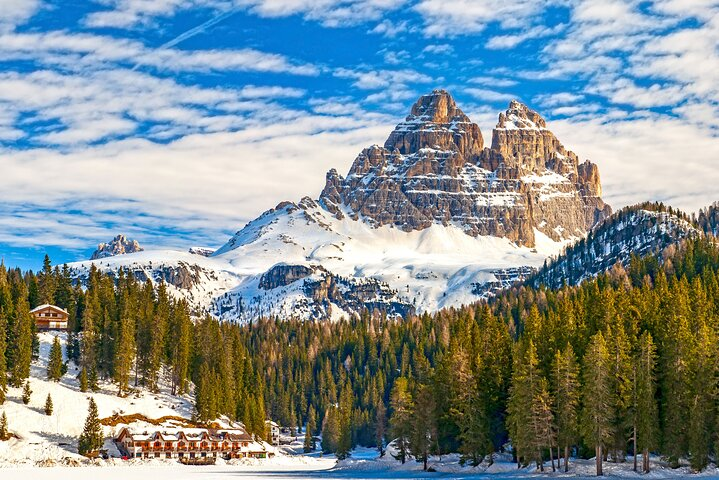 Experience the stunning contrast of snow-covered peaks and serene landscapes in the Dolomites offering unforgettable moments and breathtaking views during your winter adventure from Venice.