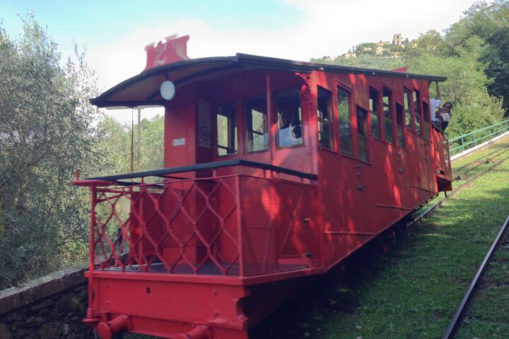 Experience a charming ride on the historic funicular offering scenic views as you ascend to Montecatini Alto immersing yourself in the unique landscapes of Tuscany.