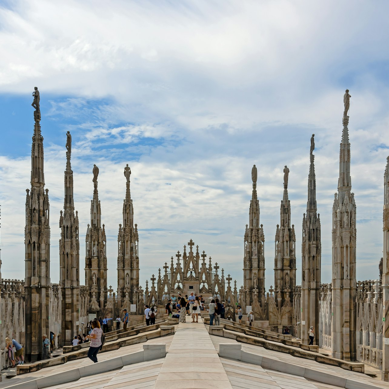 Experience stunning panoramic views of Milan from the Duomo rooftop where intricate architecture meets the sky offering a unique insight into the city’s rich history and beauty.