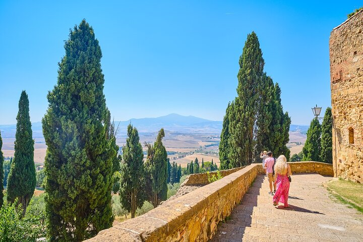 Explore the stunning landscapes of Val d'Orcia where picturesque vineyards meet medieval charm delighting in wine and artisanal cheeses while strolling along scenic pathways. A sensory adventure awaits.