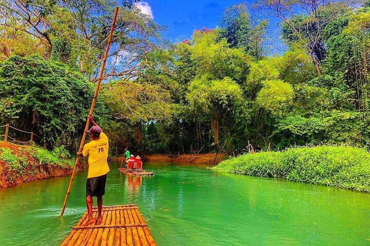 Your adventure begins with a serene rafting experience down the picturesque Martha Brae River, where you can soak up the sun.