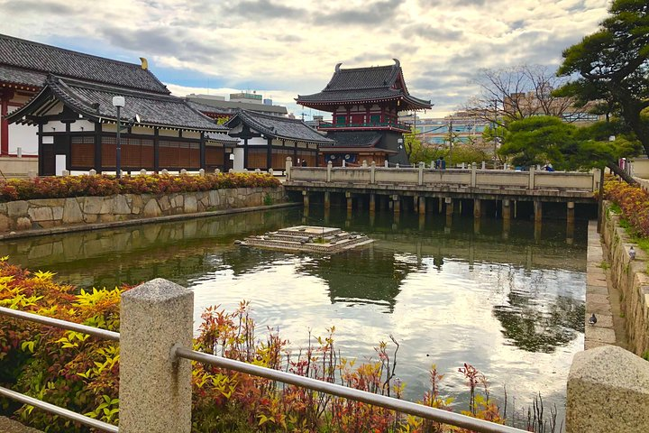 Discover the charm of Osaka as you stroll past serene waters traditional architecture and lush greenery immersing yourself in the rich tapestry of Japanese culture and history.