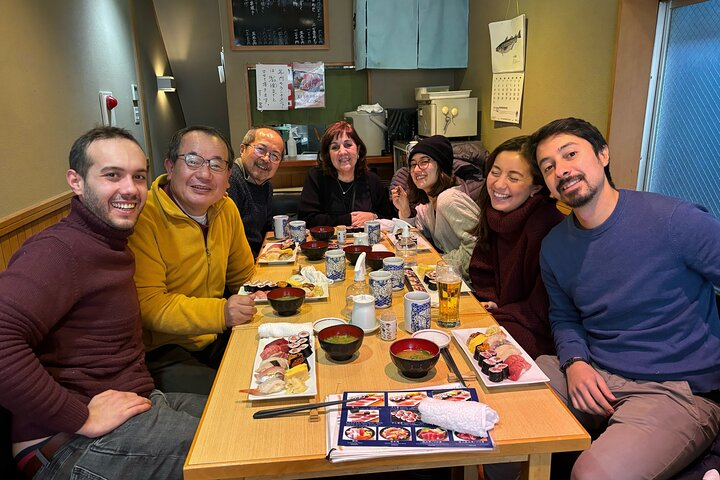Savor authentic sushi amid laughter and camaraderie where local flavors meet friendly conversation enriching your Tokyo experience at a beloved Tsukiji restaurant. A true culinary delight awaits!