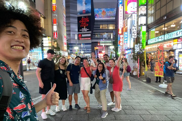 Explore Shinjuku's neon streets with a local guide discovering hidden gems unique bars and authentic cuisine while enjoying engaging conversations and local culture in a fun group setting.