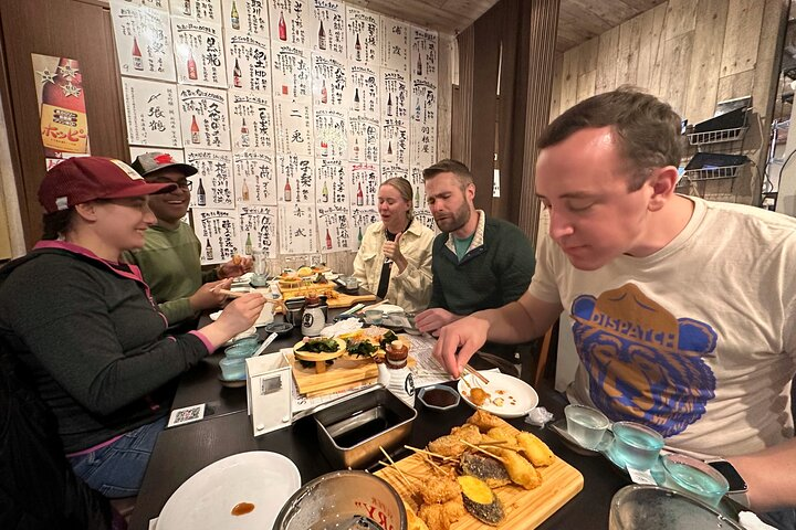 Savor the authentic flavors of Osaka with locals enjoying delicious dishes in cozy eateries and sharing stories that bring the city's nightlife to life. Experience culinary delights like never before.