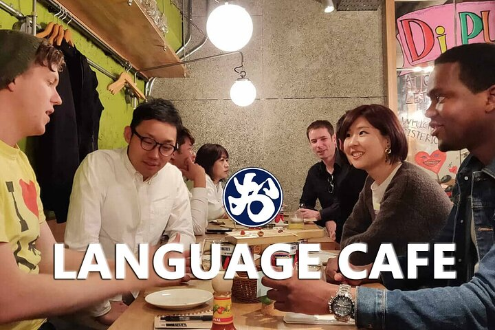Engage in friendly conversations and culture sharing over drinks in a cozy café-bar setting while honing your Japanese skills with welcoming locals in Osaka. A unique social experience awaits!