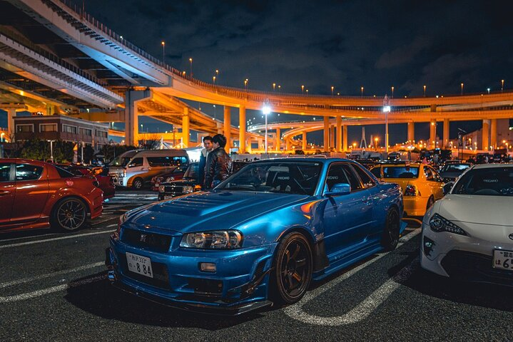Experience the thrill of Japanese car culture at Daikoku Parking surrounded by iconic cars and the stunning Tokyo skyline. Connect with locals and explore the city's most scenic spots.