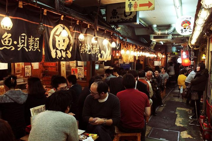 Experience the charm of Ebisu’s nightlife where food stalls brim with local delicacies and laughter fills the air inviting you to savor authentic Japanese culinary treasures with fellow food enthusiasts.