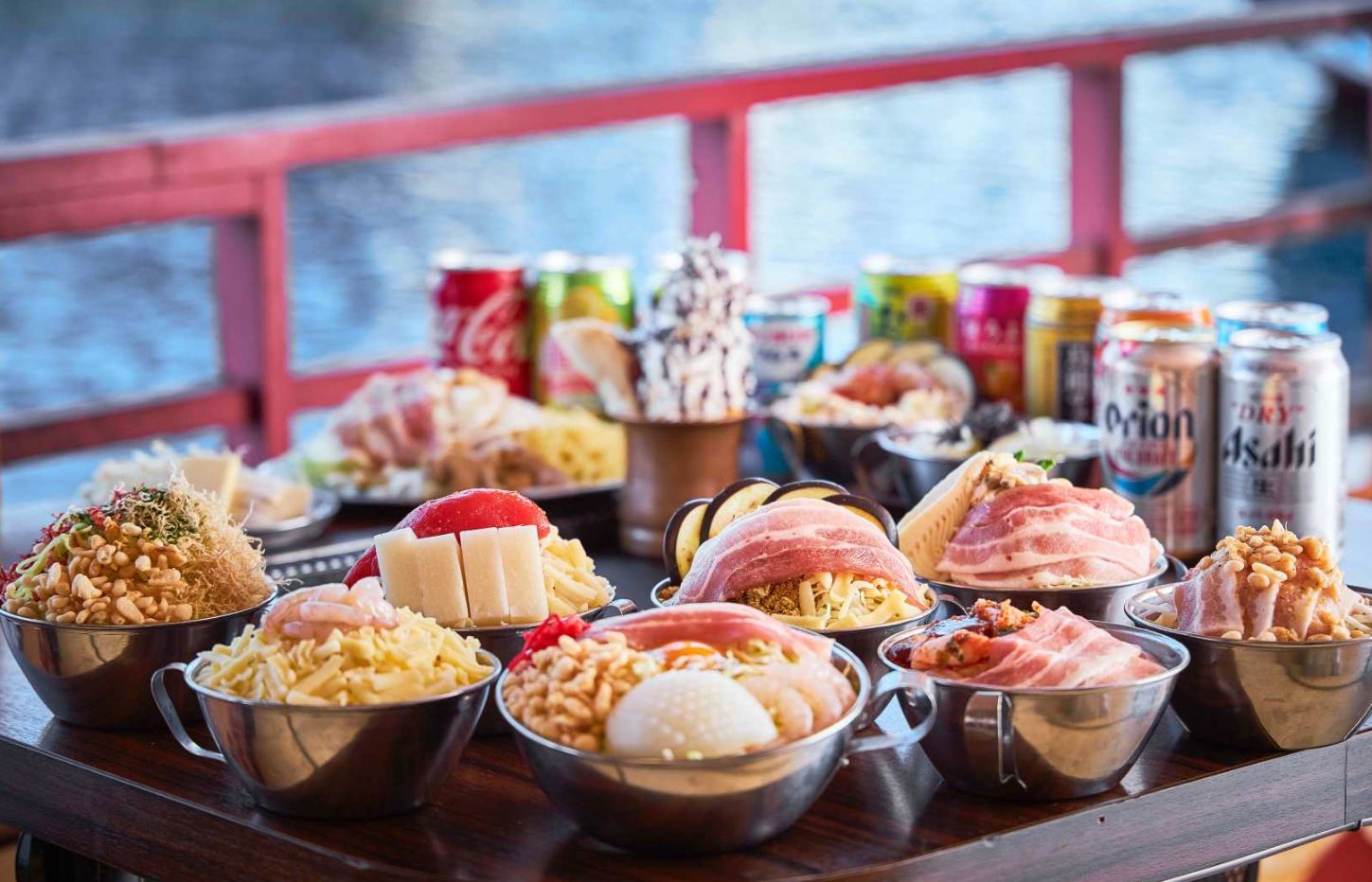 Savor the flavors of Monjayaki aboard the Edomae Yakatabune cruising Tokyo Bay against a backdrop of shimmering city lights promising a delightful culinary adventure.