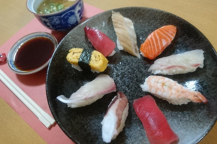 Immerse yourself in a unique culinary experience as you craft nigiri-sushi and miso soup alongside a skilled instructor enjoying delightful creations with a small group.