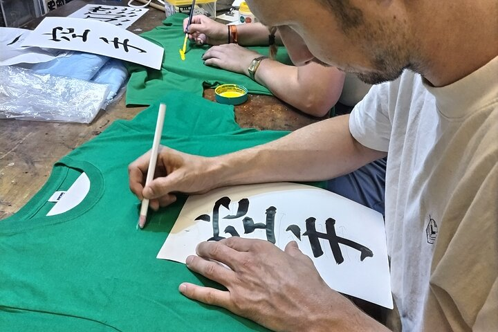 Experience the joy of Japanese calligraphy by creating meaningful Kanji on T-shirts surrounded by fellow travelers as you immerse yourself in the rich culture of Sumida Tokyo.