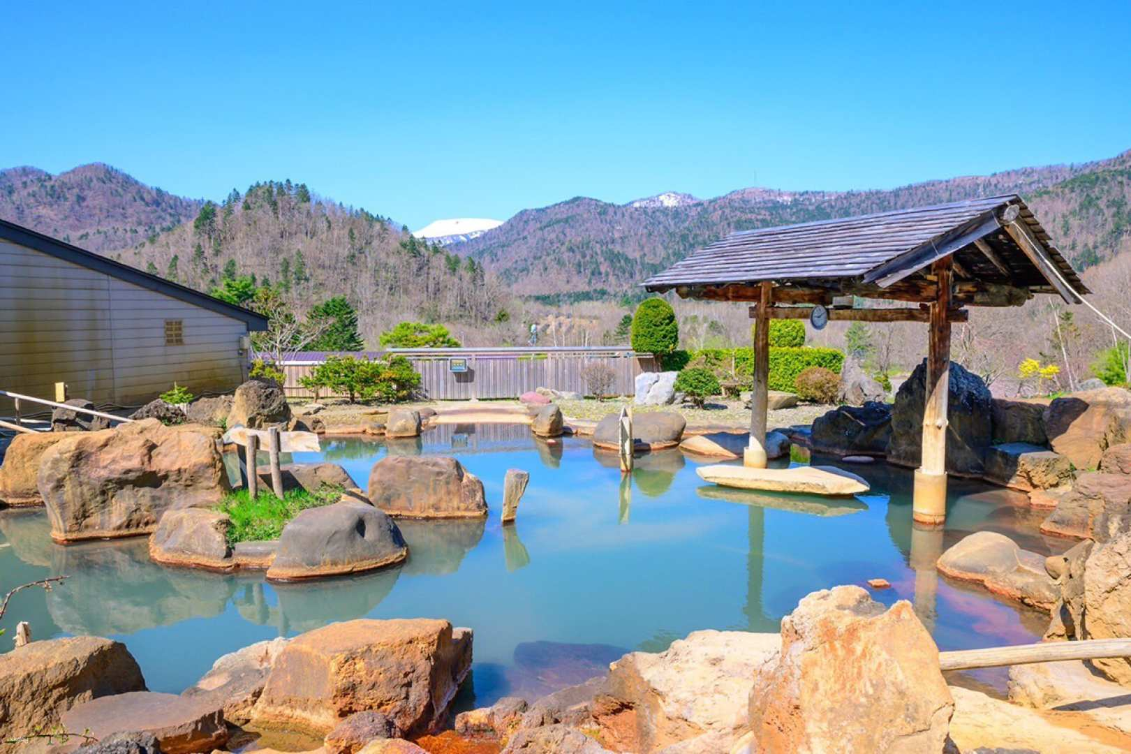 Relax in a tranquil open-air bath surrounded by stunning snowy landscapes savor local hot springs cherished by residents and indulge in delicious Indian curry—all with hassle-free private transport.
