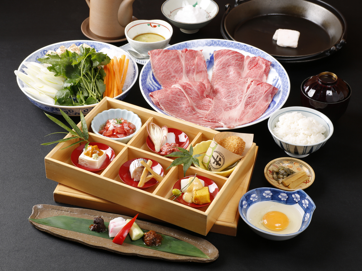 Indulge in a delightful culinary experience with Ise Black Beef featuring a spread of fresh ingredients exquisite flavors and the unique charm of Tokyo's Butasute Kitte Marunouchi Branch.