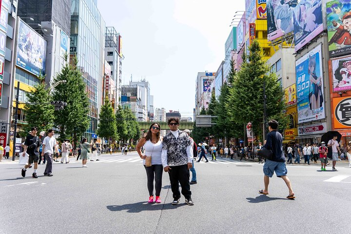 Experience the bustling streets of Akihabara where giant billboards and lively crowds set the stage for an unforgettable adventure filled with anime culture and delicious Japanese cuisine.