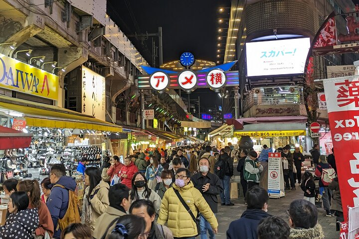Experience the lively charm of Ueno's Ameyoko Market where the tantalizing aroma of street food and the bustle of locals create unforgettable culinary adventures at every turn.