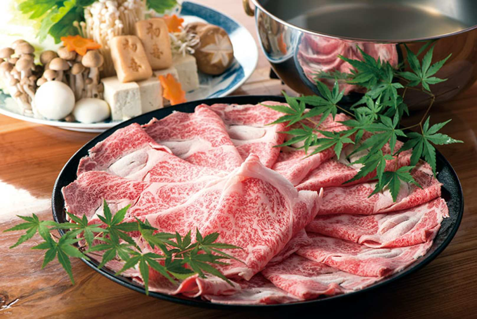 Indulge in the exquisite flavors of Kuroge Wagyu with a serene dining experience at Nishishin Hatsuki KUTEN in Fukuoka featuring perfectly arranged meats and traditional Japanese cuisine.