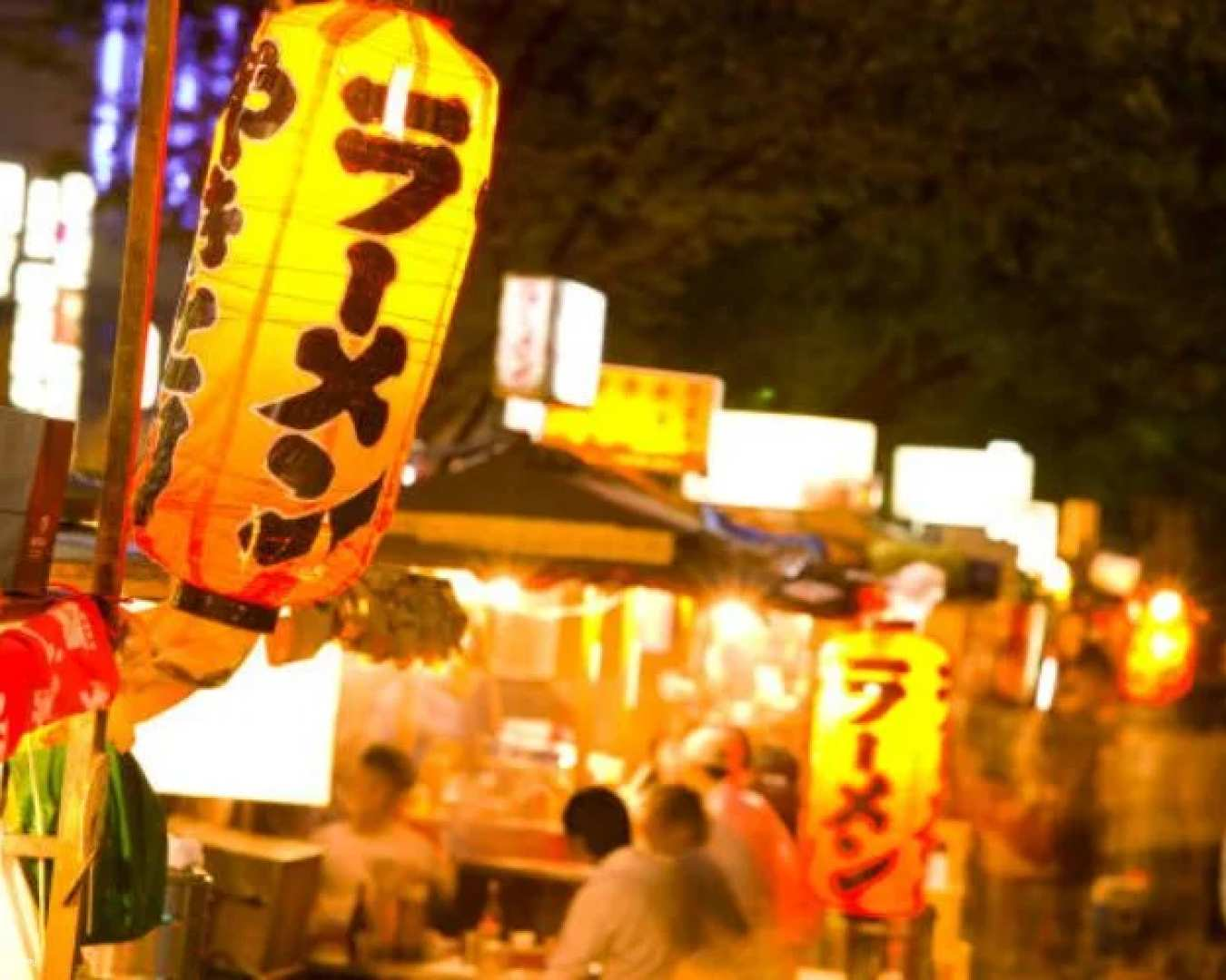 Savor the lively essence of Fukuoka’s street food scene sampling local dishes while exploring bustling stalls and engaging with your knowledgeable guide immersed in culinary delights.