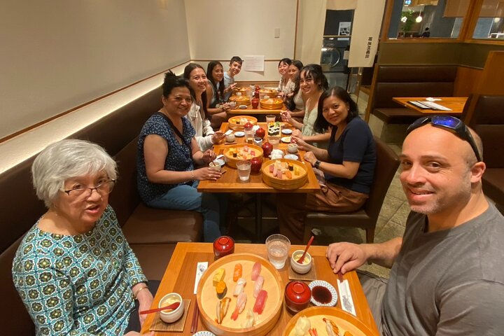 Experience the joyful moments of culinary exploration in Tokyo sharing delicious dishes with fellow travelers while connecting with the city’s rich culture and hidden gems.