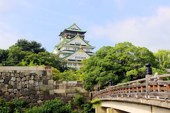 Explore the stunning architecture of Osaka Castle surrounded by lush greenery. Wander across picturesque bridges and discover the fascinating blend of history and culture that defines Osaka.