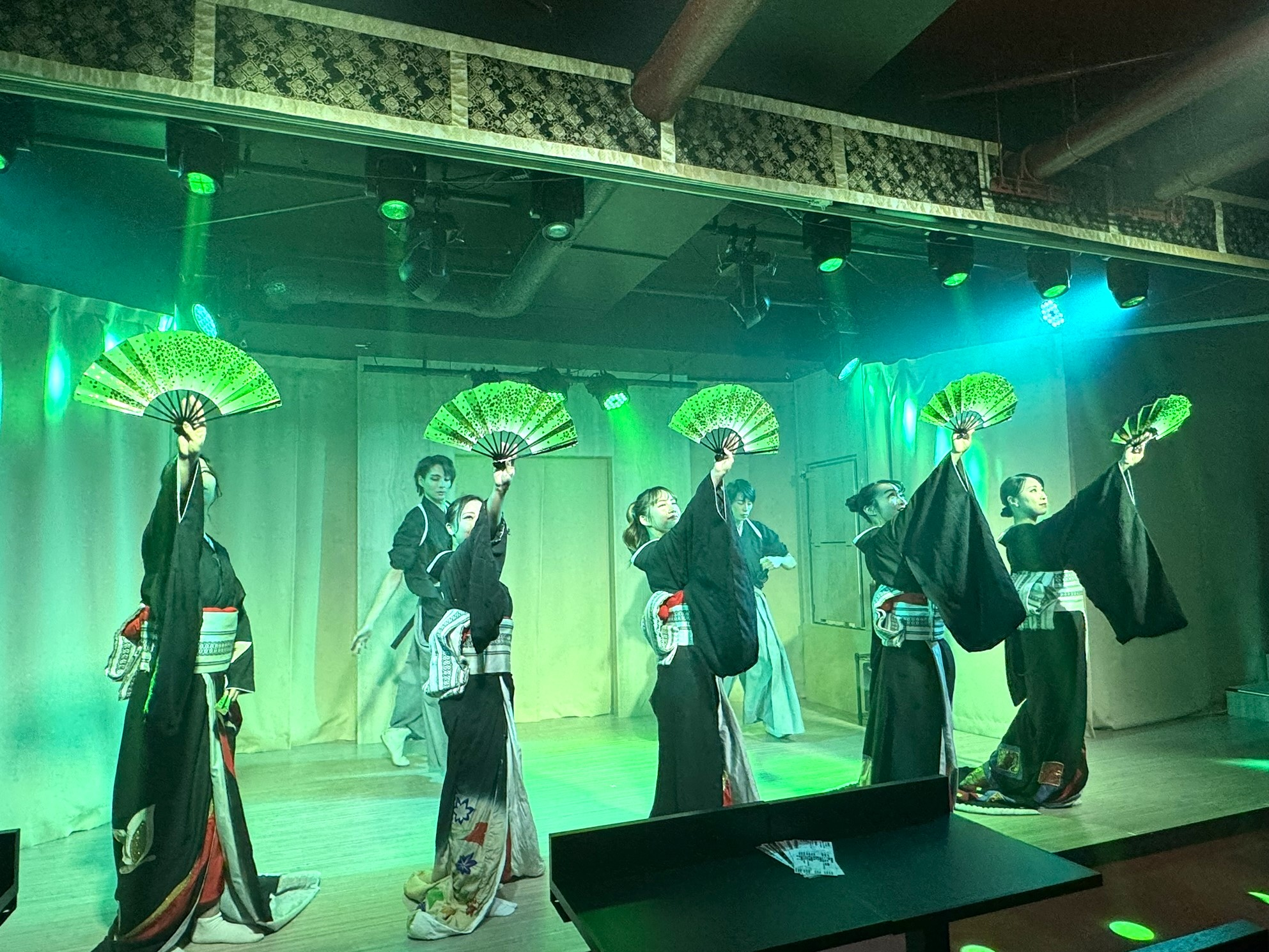 Experience the charm of traditional Japanese performance as dancers showcase their artistry with fans creating an unforgettable night in Tokyo's Asakusa. Drink in the culture while you relax!